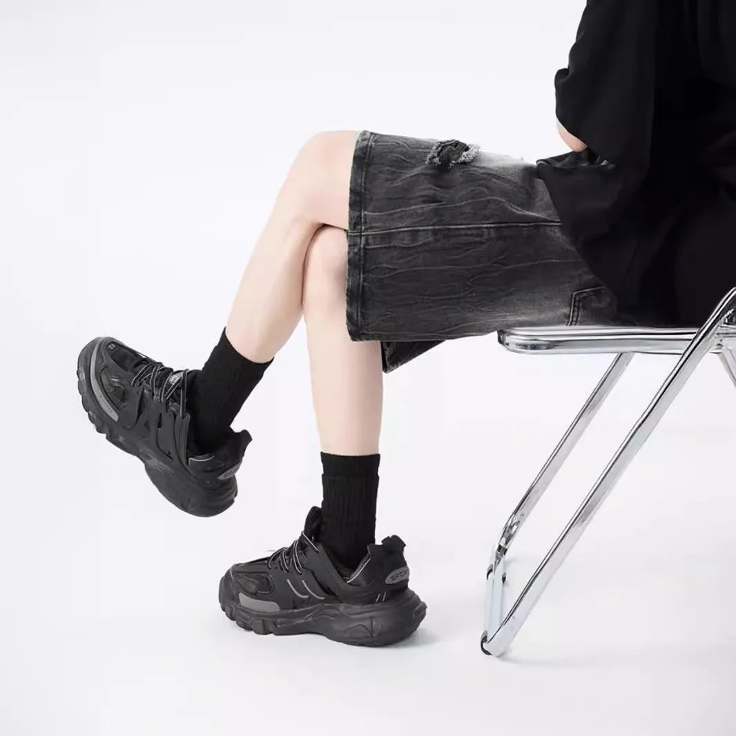 Washed black denim shorts with ripped details and a loose retro fit.
