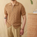 Man's light brown cotton cardigan with a front zipper, lapel collar, and short sleeves laid flat.