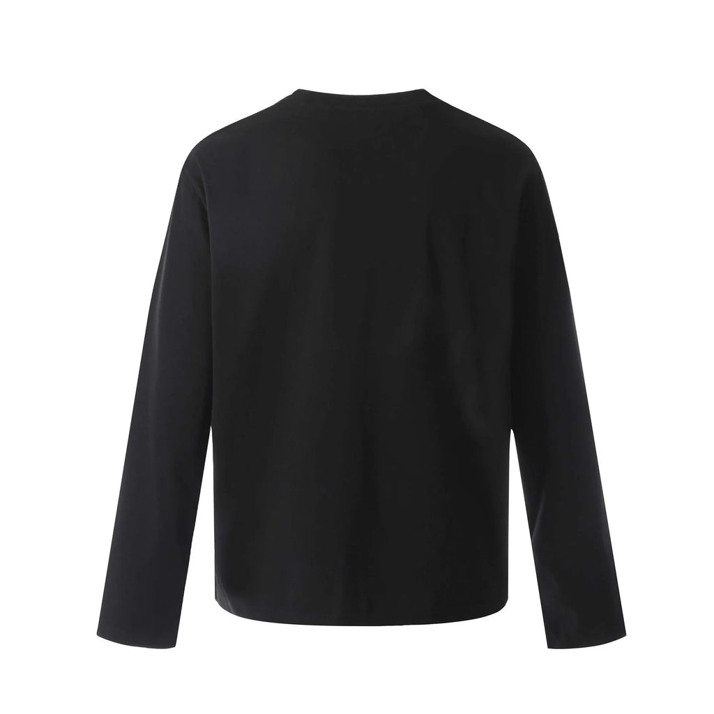 Man wearing a grey loose fit cotton long sleeve pullover with a simple retro design.