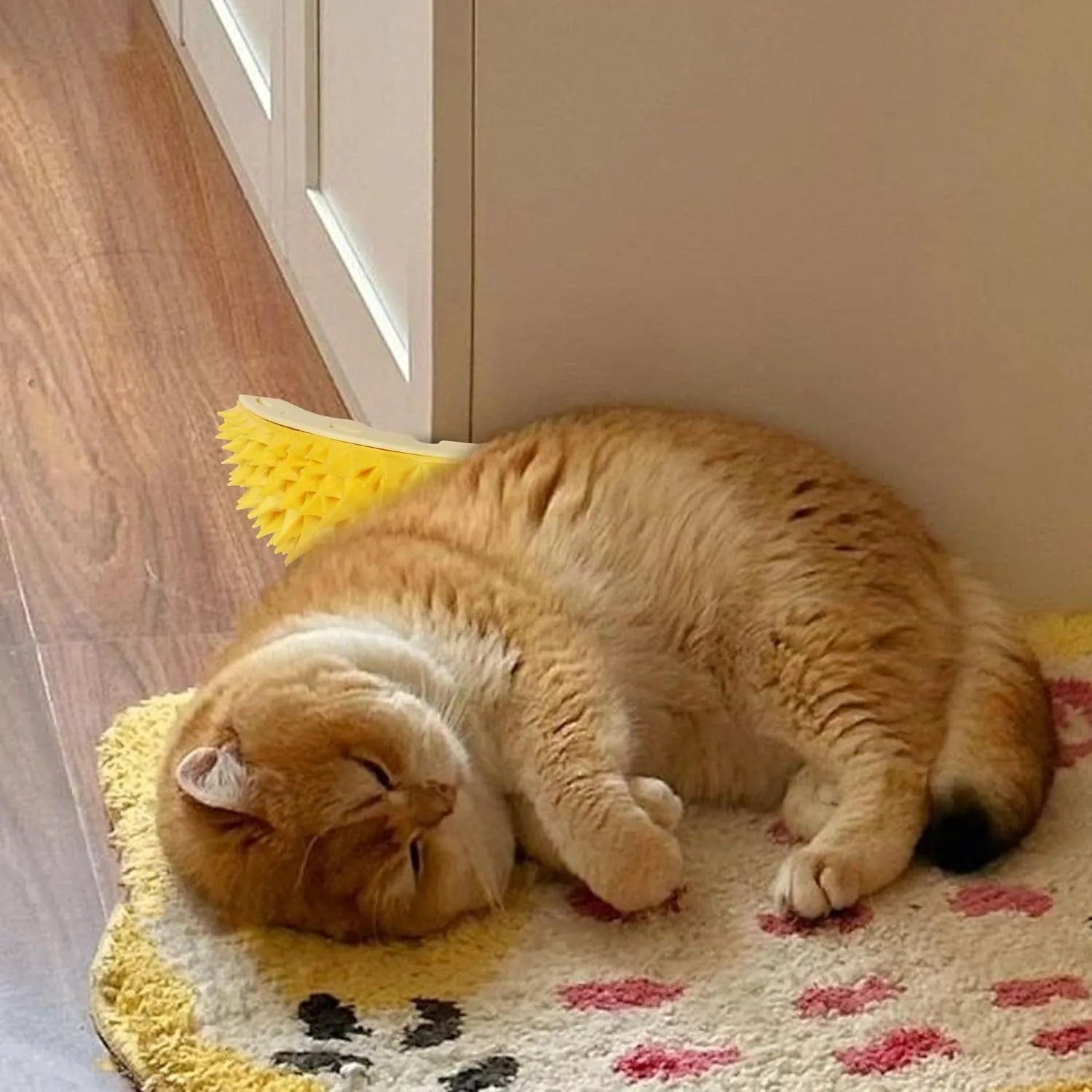 Yellow durian-shaped cat corner scratcher with massage brush installed on wall