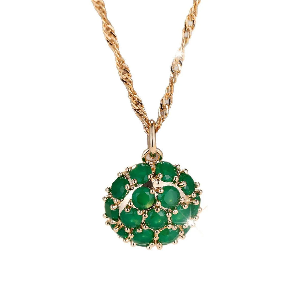 Round emerald pendant necklace with diamond setting on champagne gold chain