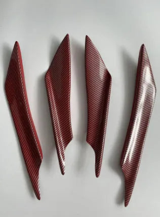 Set of four carbon fibre pattern automotive bumper blades mounted on vehicle