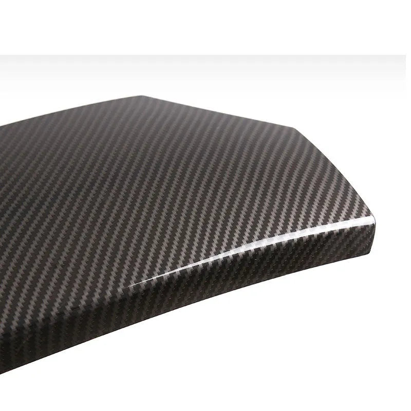 Three ABS plastic armrest box covers with a shiny carbon fibre pattern, shown next to a car centre console.