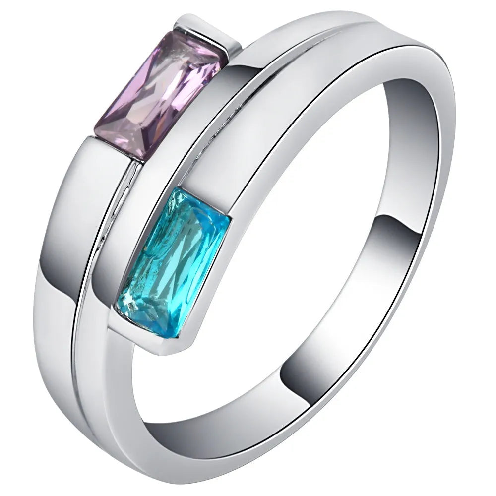 Silver-coloured copper ring with decorative zircon stone inlays on finger