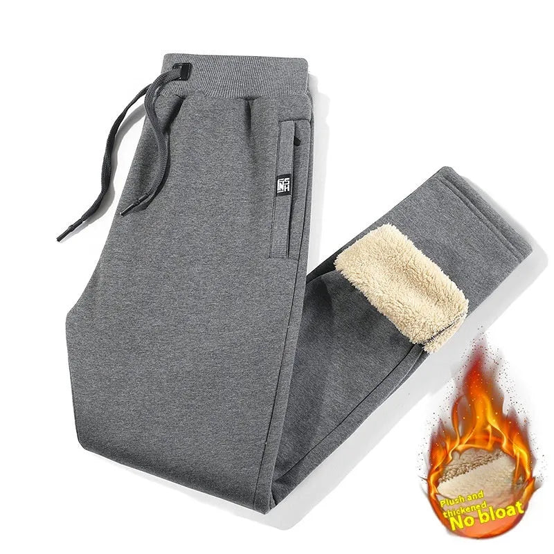 Men's grey fleece-lined oversized cotton track pants with a straight leg on a hanger.
