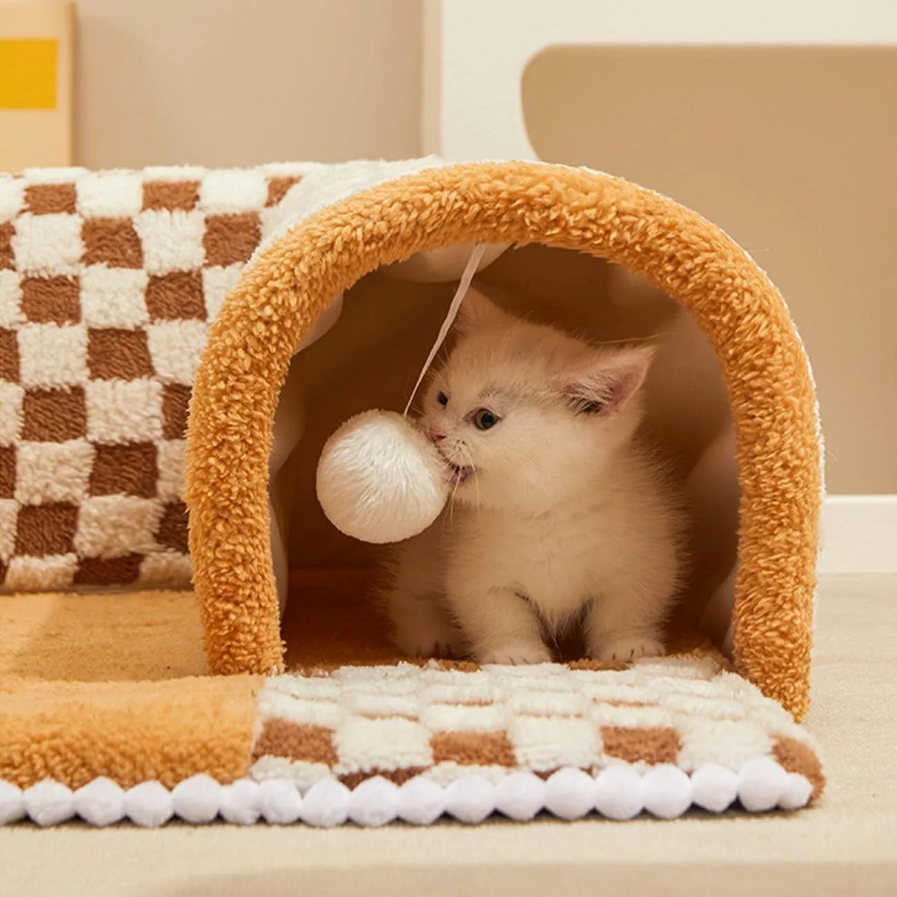 Fan-shaped plaid pet bed with integrated tunnel for dogs and cats in coffee colour, showing soft plush fabric.