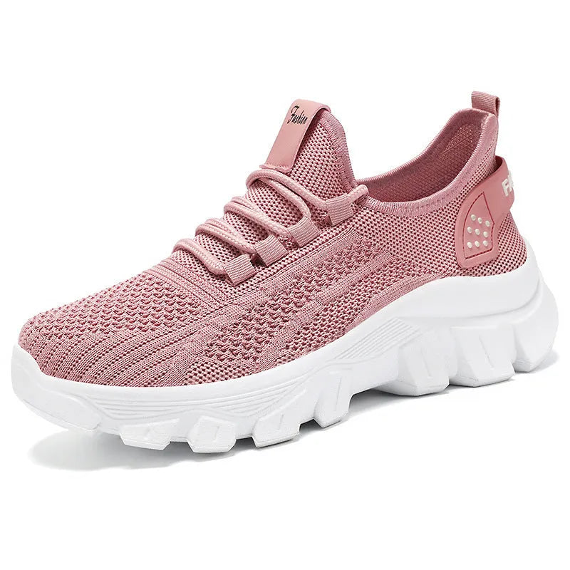 Women's white Flyknit sneakers with a thick PVC sole and lace-up front.
