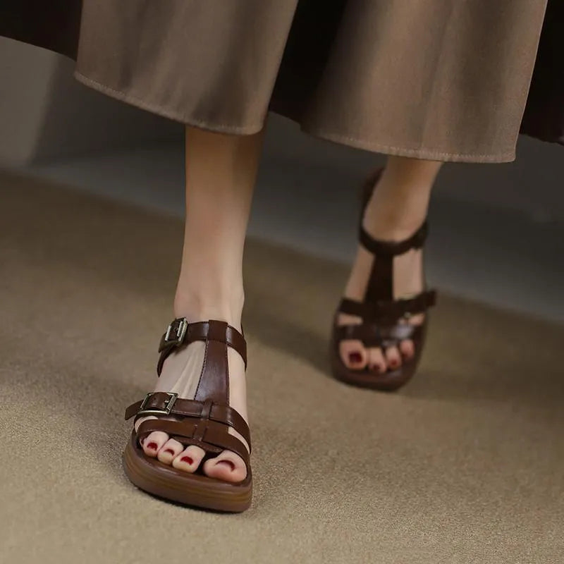 Black retro women's sandals with a T-shaped buckle, open square toe, and a chunky platform heel.