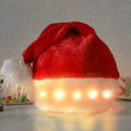 Red and white plush LED Santa hat with pom-pom and 20 multi-colour lights illuminated.