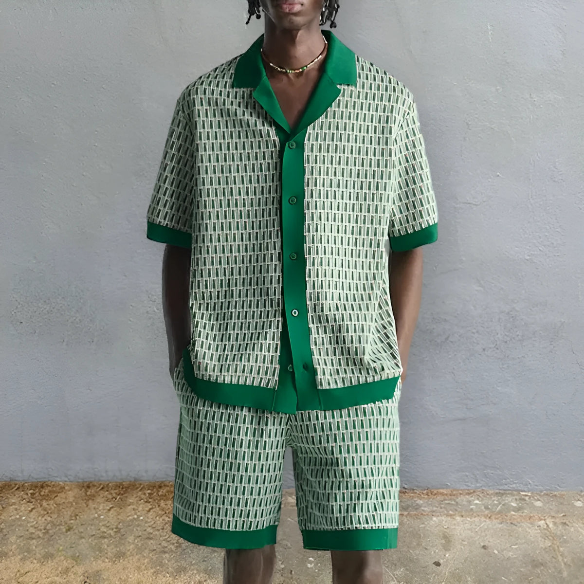 Man wearing a printed short-sleeve shirt and matching shorts from a polyester two-piece set.
