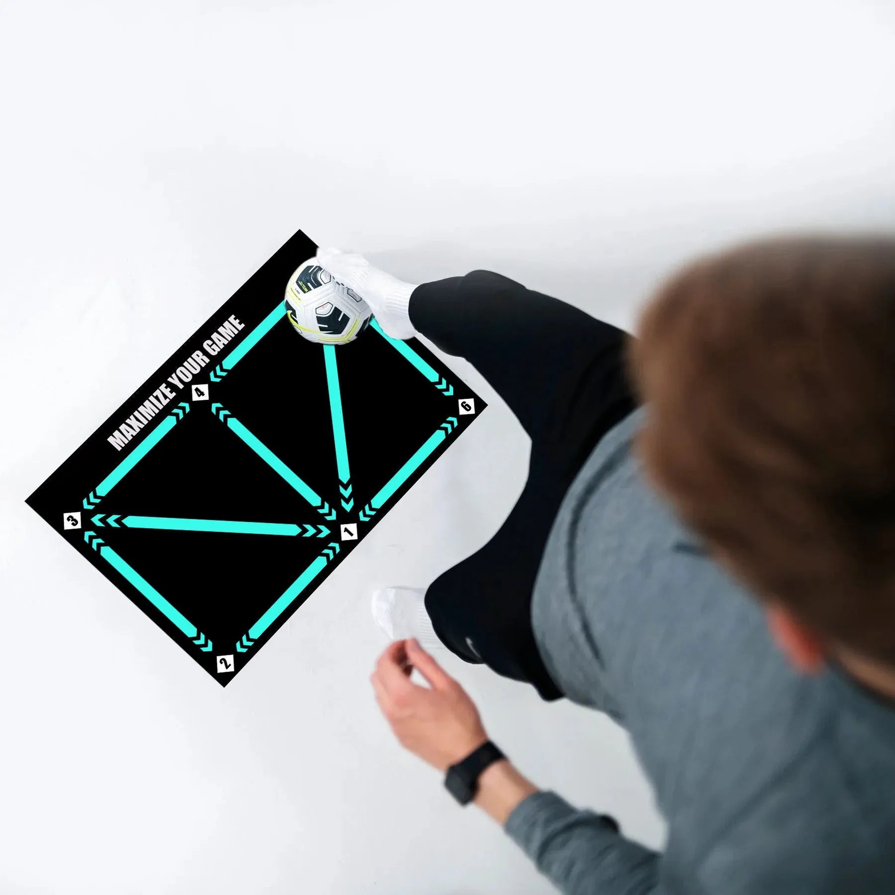 Black rectangular football training mat with non-slip surface measuring 60cm by 90cm