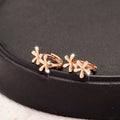 Rose gold coloured circular stud earrings with a detailed waterdrop floral design.