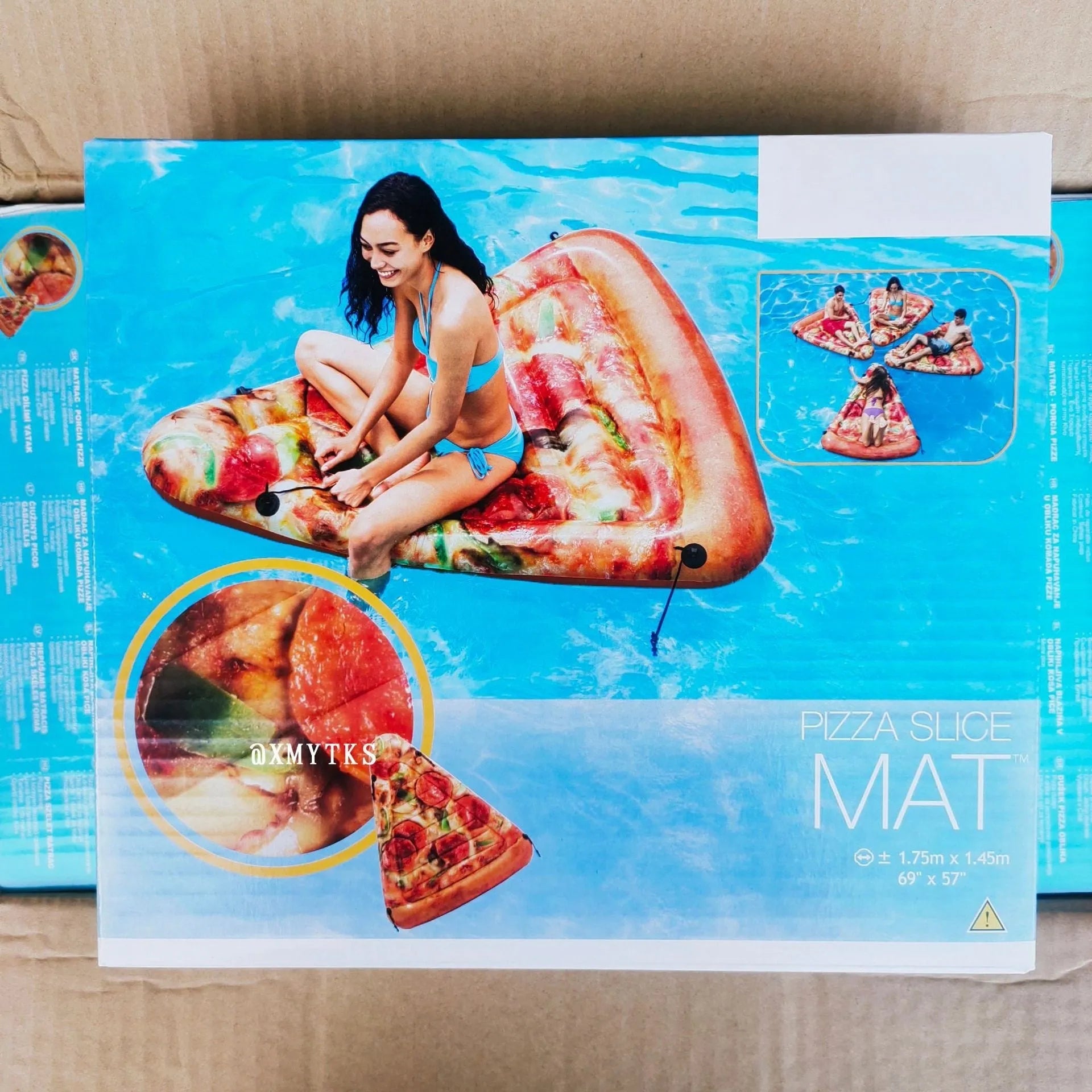 Large inflatable pizza-themed surfboard lounger floating on water.