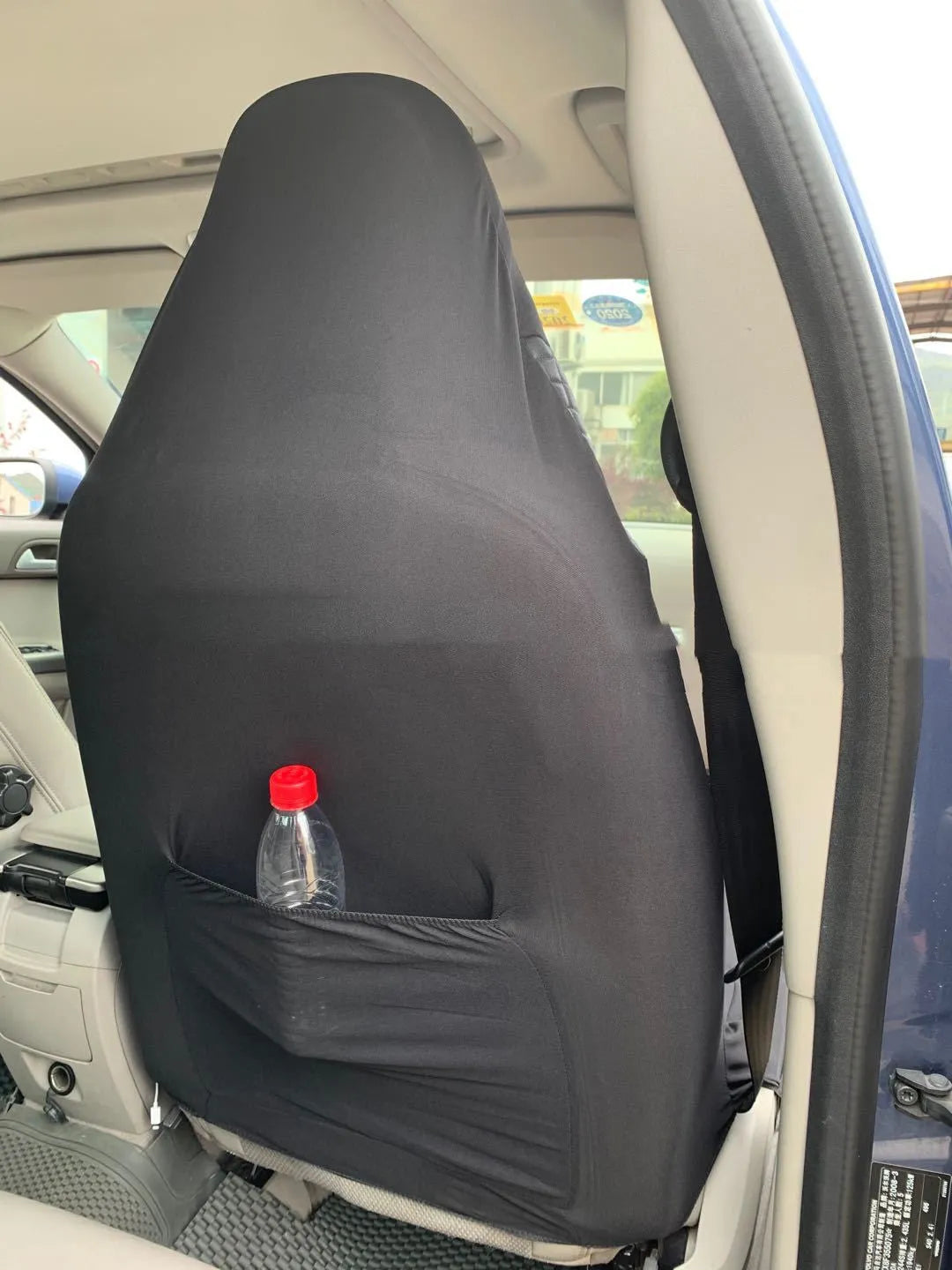 Black quilted automotive seat covers showing PU and polyester fabric construction with plastic hook fasteners