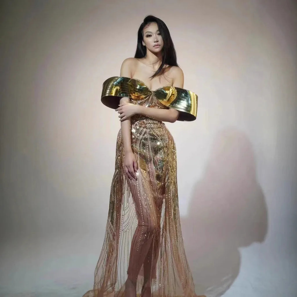 Gold sequinned strapless long evening dress with a high thigh split on a model.