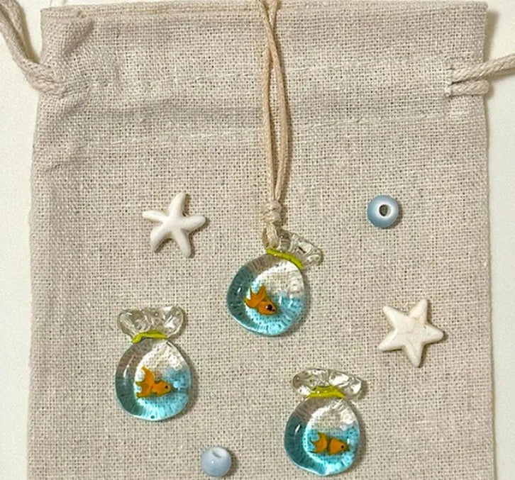 Women's joker design pendant necklace with coloured glaze charm on a cotton and linen clavicle chain.