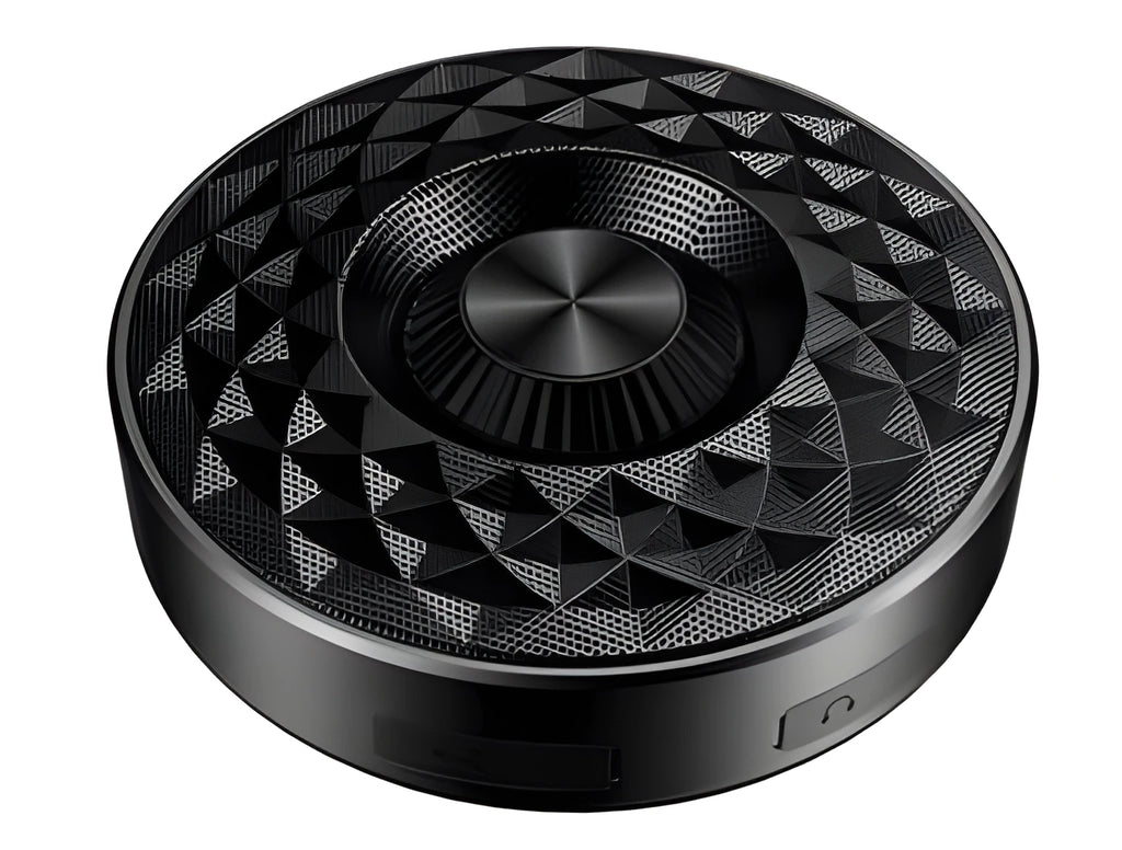 Compact black/orange/silver white portable Bluetooth speaker on a surface, showing its 360-degree grille.