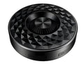 Compact black/orange/silver white portable Bluetooth speaker on a surface, showing its 360-degree grille.