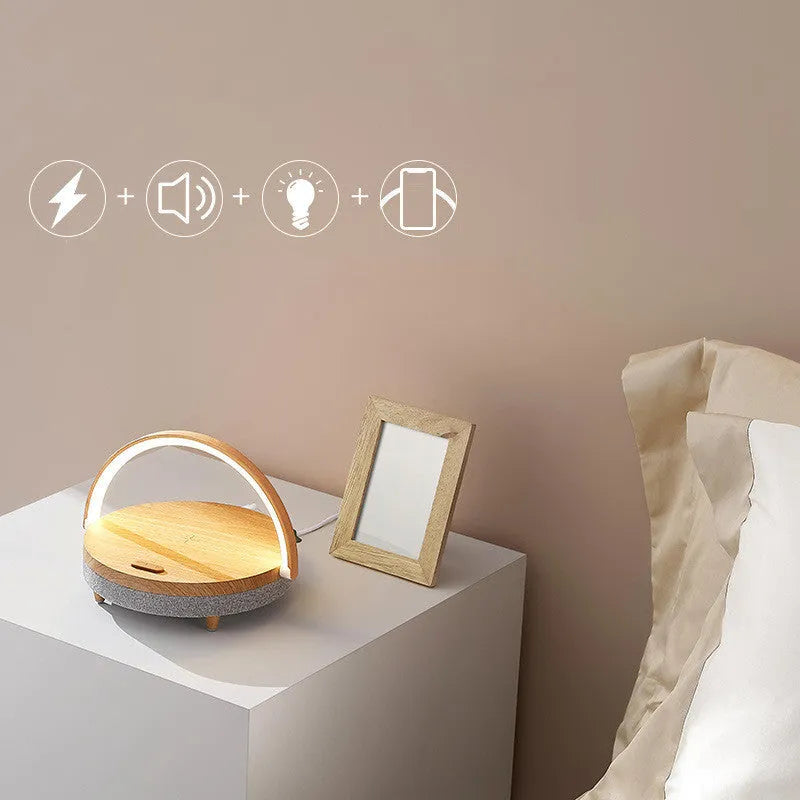 Marble pattern wireless charging night light with Bluetooth speaker and phone holder on bedside table