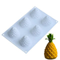 Flexible silicone baking mould with six cavities shaped like pineapple, pine cone, and pear fruit.