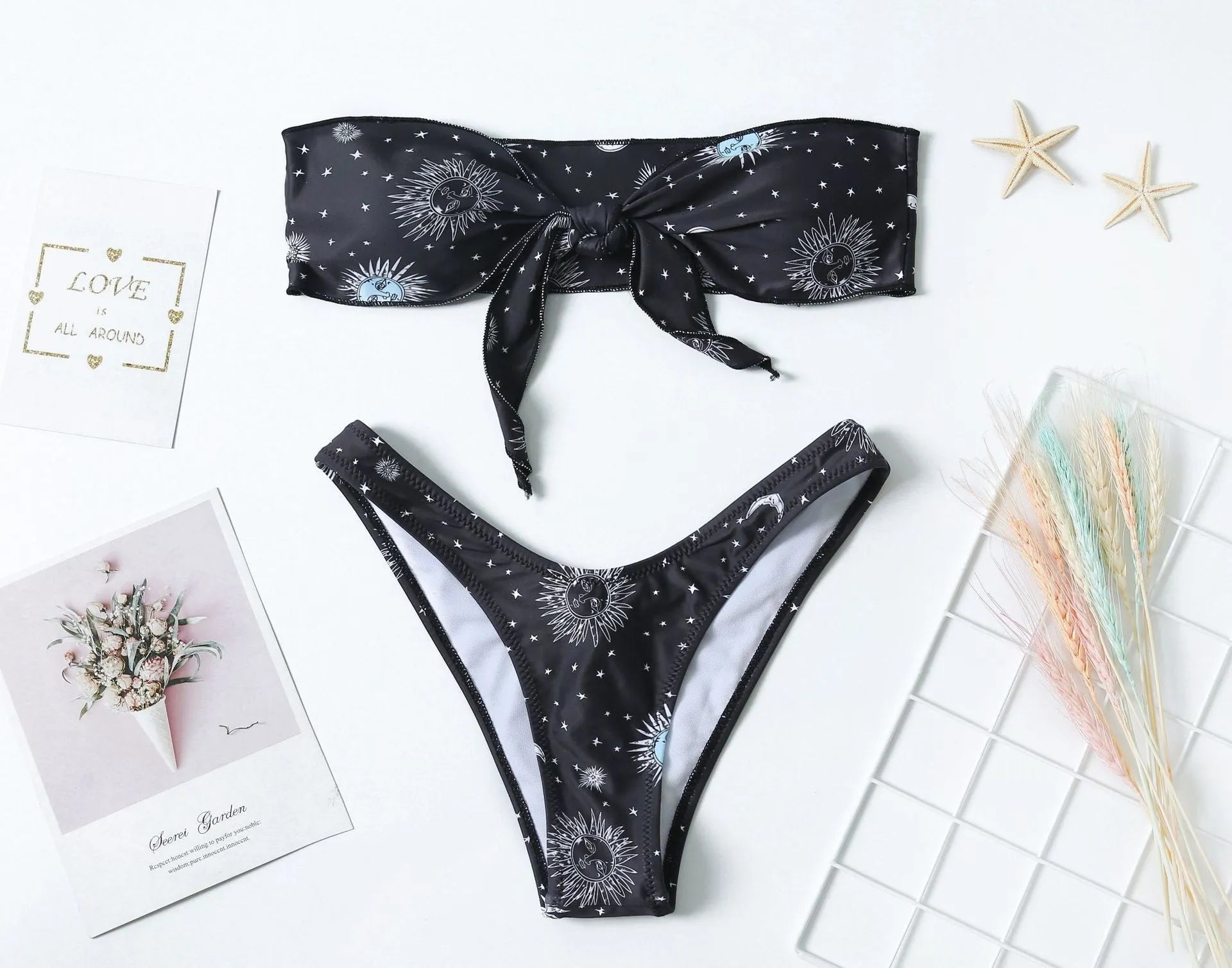 Black nylon one-piece swimsuit with bikini print pattern and backless tube top design