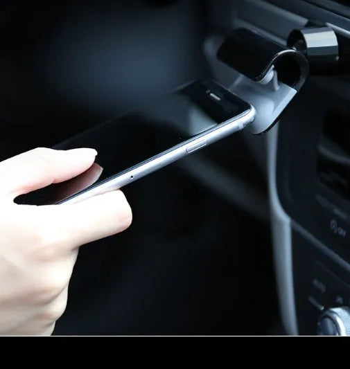 Black 360-degree rotating car phone holder mounted on car air vent with smartphone attached