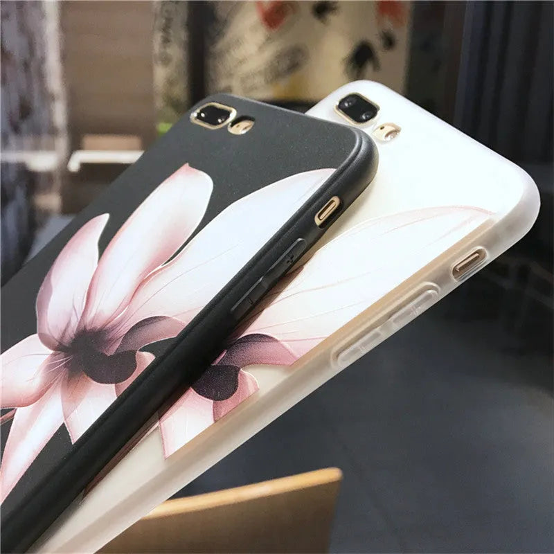 Black TPU iPhone case with a raised white embossed floral pattern on the back.