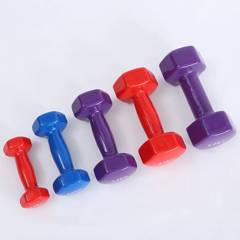 Bright colourful plastic dumbbells for home fitness workouts with glossy floor-protecting surface