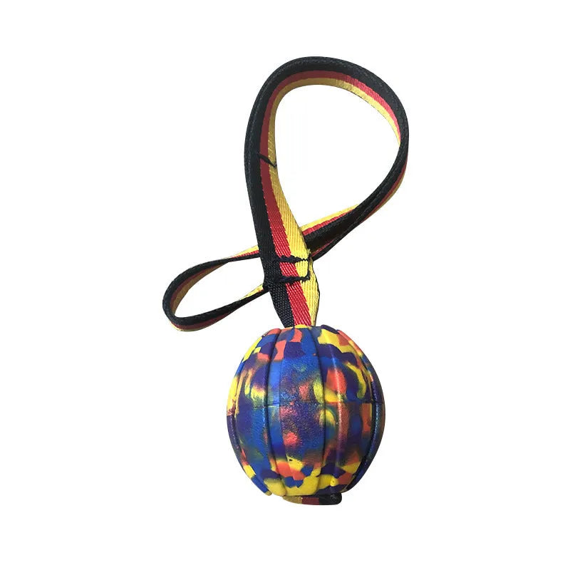 Yellow EVA floating dog ball with string attached, next to a camouflage coloured version on a blue background.