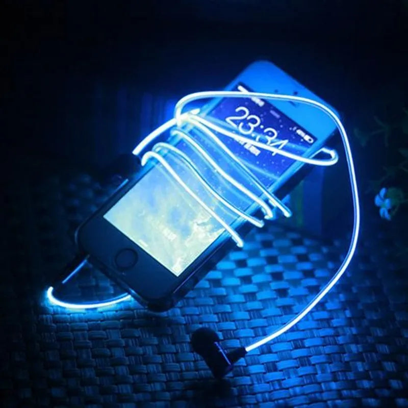 Close-up of blue LED earphones with aluminium alloy shells lit up, showing 3.5mm plug and inline remote.