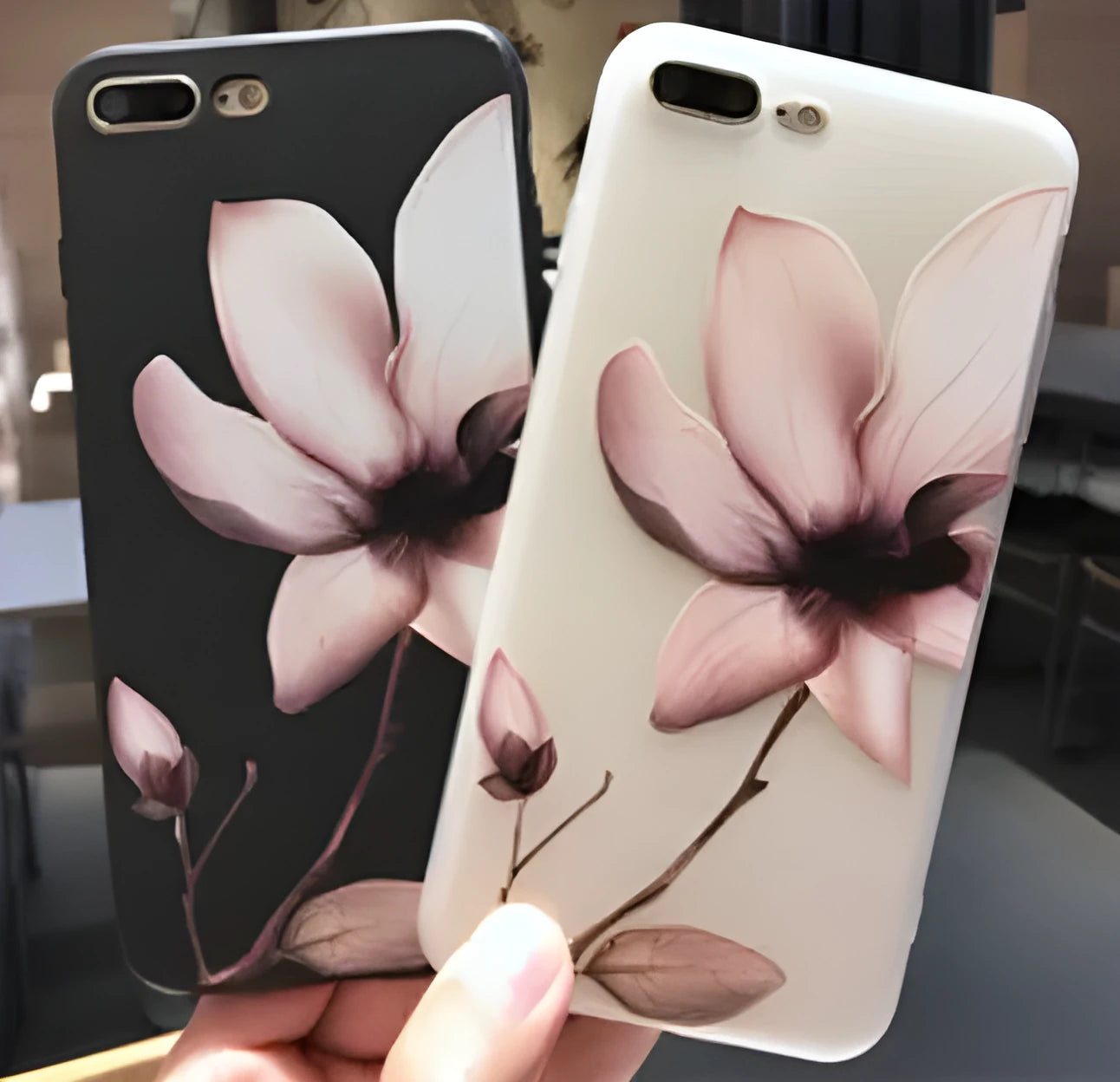 Black TPU iPhone case with a raised white embossed floral pattern on the back.