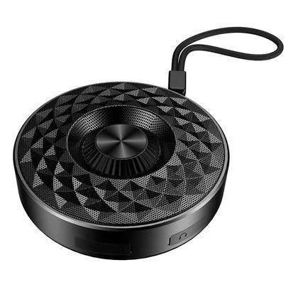 Compact black/orange/silver white portable Bluetooth speaker on a surface, showing its 360-degree grille.