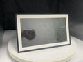 White smart digital photo frame with 15.6 inch screen on a table.