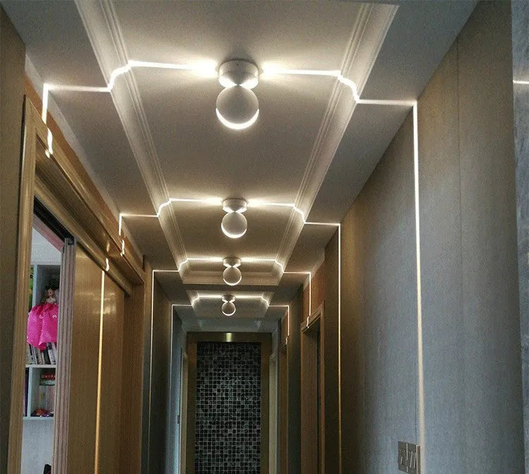 Modern aluminium and glass LED spotlight bar wall lamp mounted on a wall.