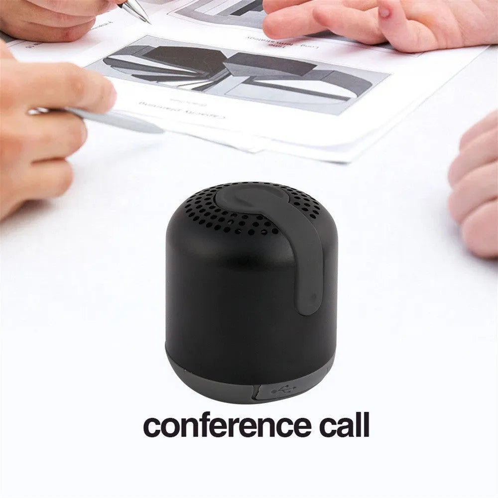 Hieha XQ11 cylindrical mini portable Bluetooth speaker in silver colour on a table.