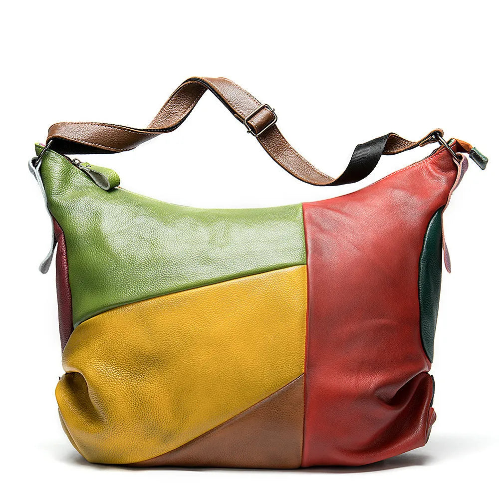 Brown cowhide leather crossbody travel bag open showing space for a laptop and personal items.