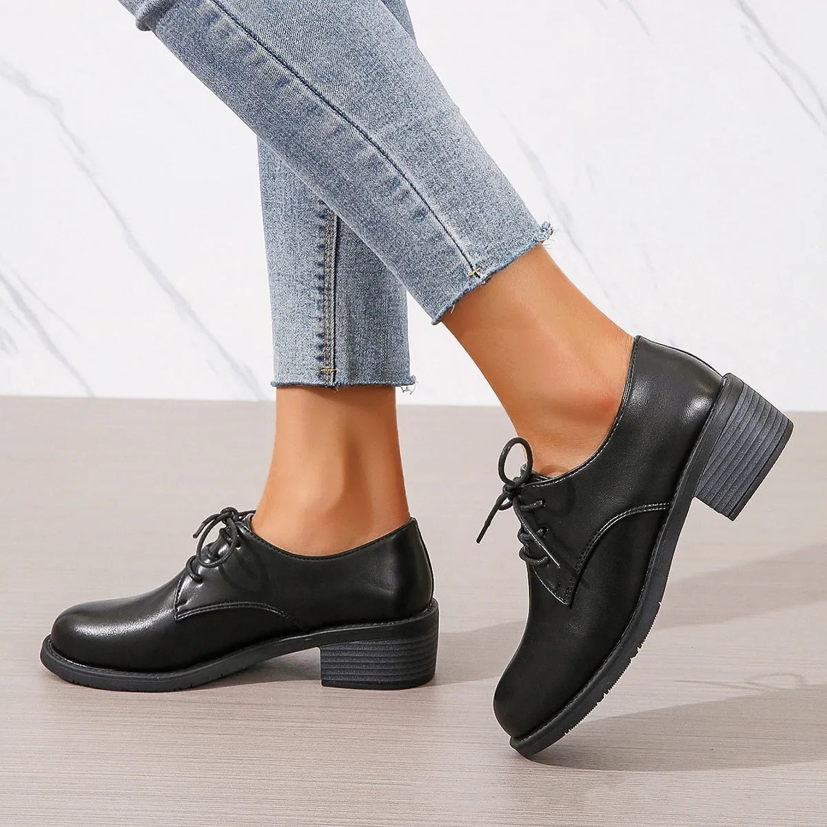 Black women's low-top work shoes with a thick chunky heel and round toe.