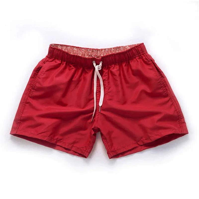 Men's polyester beach shorts for surfing in multiple colours including black white red and fluorescent options