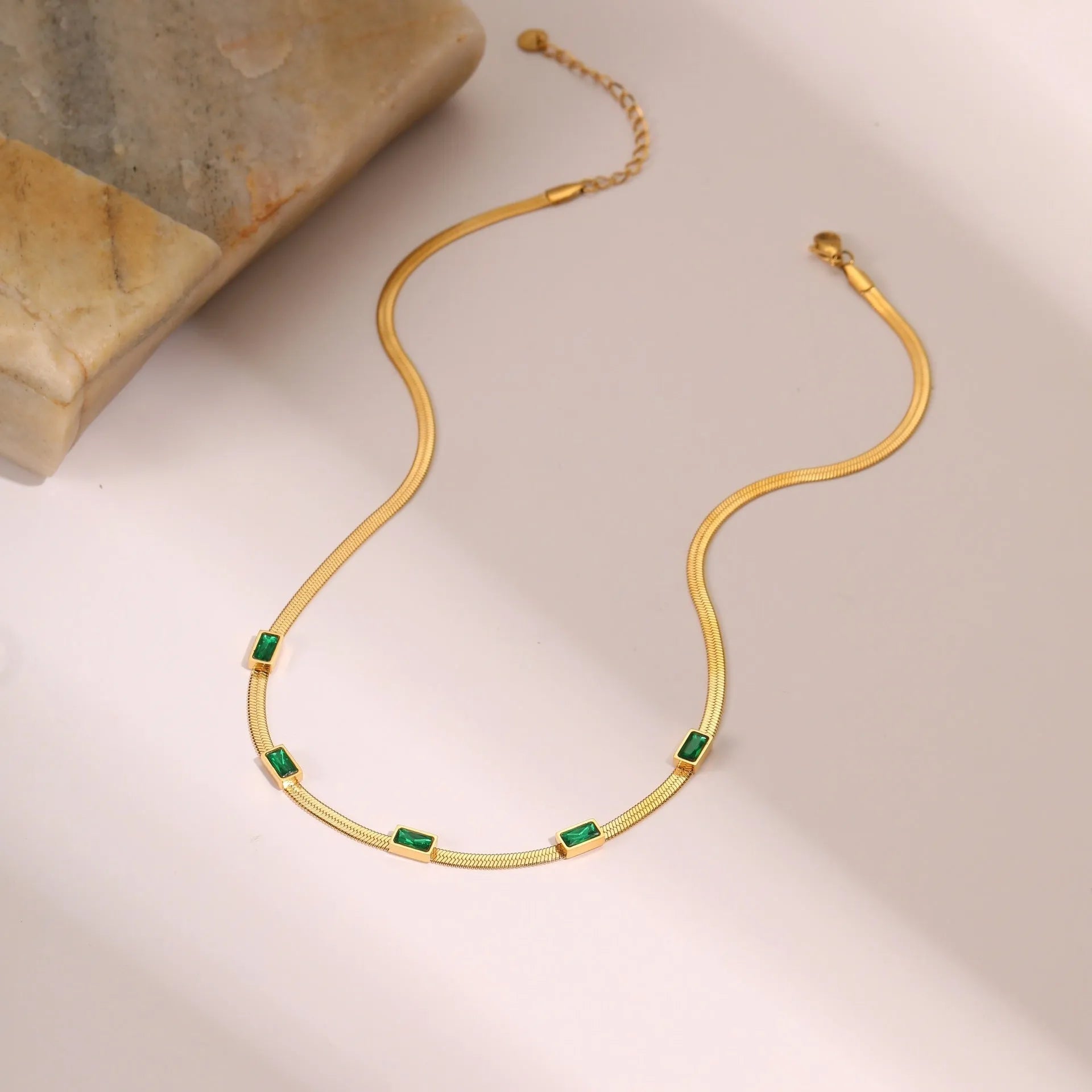 Geometric square zircon necklace in stainless steel with electroplated gold finish showing quadrilateral pattern