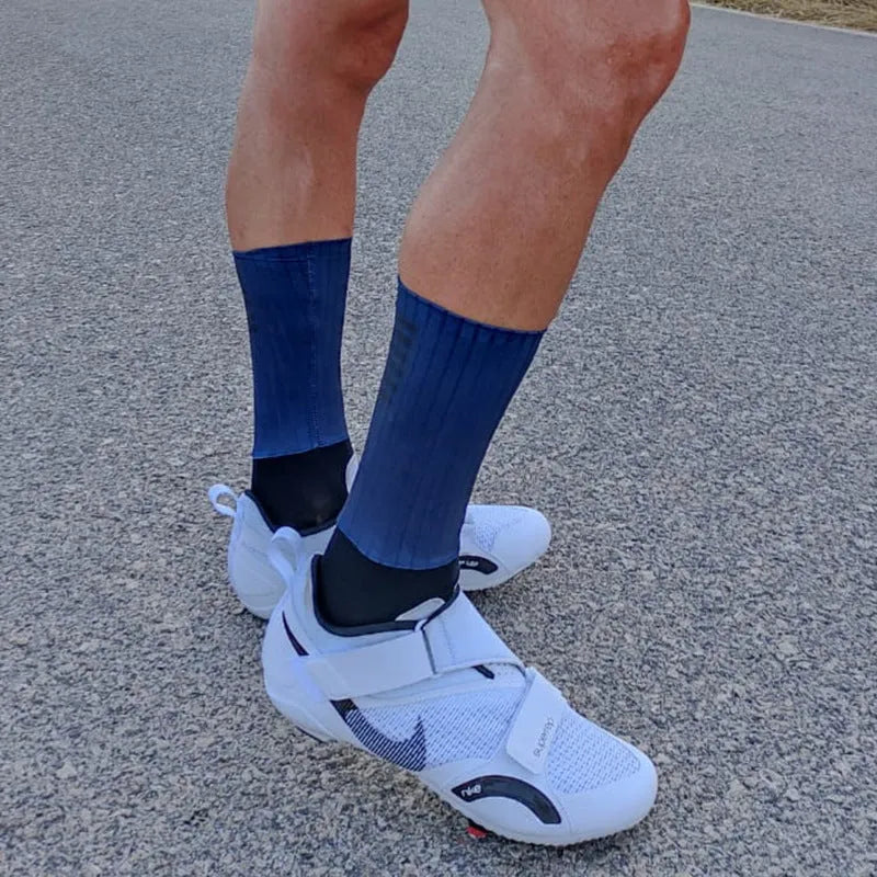 Athletic sports socks for cycling and running in six colour options including orange, black, and purple.