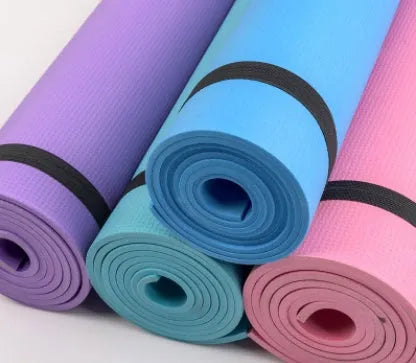 Red EVA fitness yoga mat showing texture and thickness, rolled partially with carry bag.
