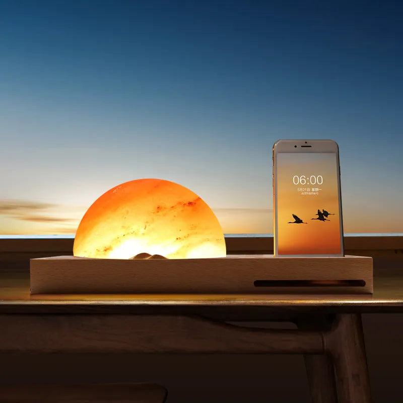 Sunrise Oriental table lamp with natural salt shade on wood base, showing wireless phone charging.