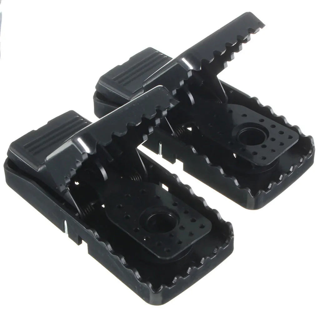 Six black plastic snapping mousetraps showing 11cm length and biting mechanism