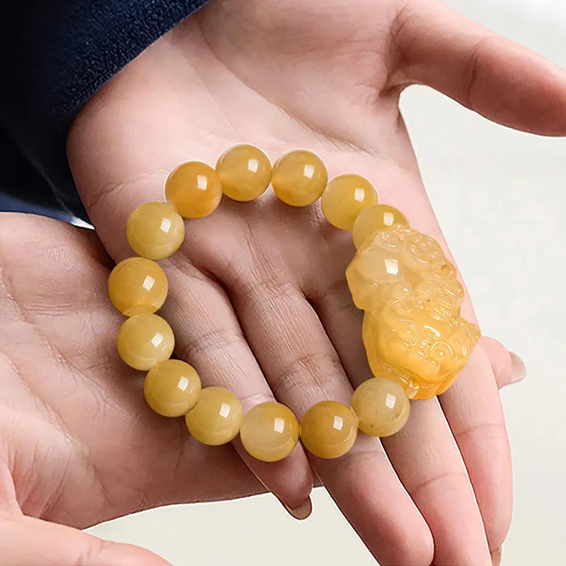 Golden thread Jinsi Jade money bracelet with carved coin charms on beaded strand