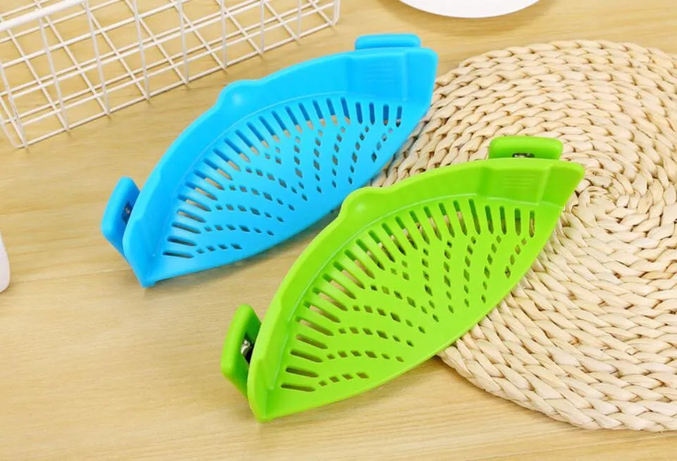 Silicone clip-on funnel colander in kitchen draining liquid from pot