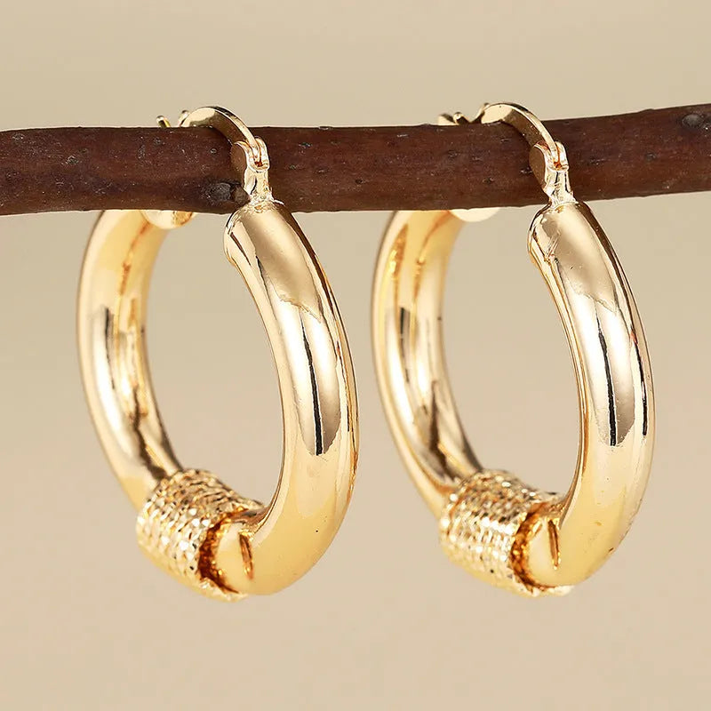 Geometric women's earrings with ring ear clip design in golden copper material