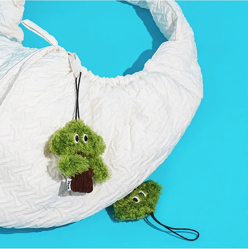 Pine tree-shaped hanging cat chew toy with mint filling, shown next to a ruler for scale
