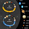 Two natural stone beaded bracelets on a surface, showcasing zodiac sign designs.