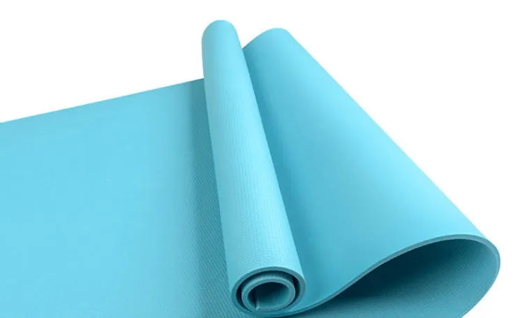 Red EVA fitness yoga mat showing texture and thickness, rolled partially with carry bag.