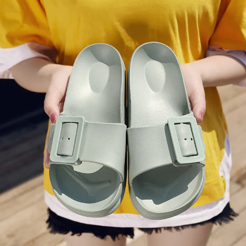 Women's grey blue buckle flip flop sandals with EVA sole on neutral background